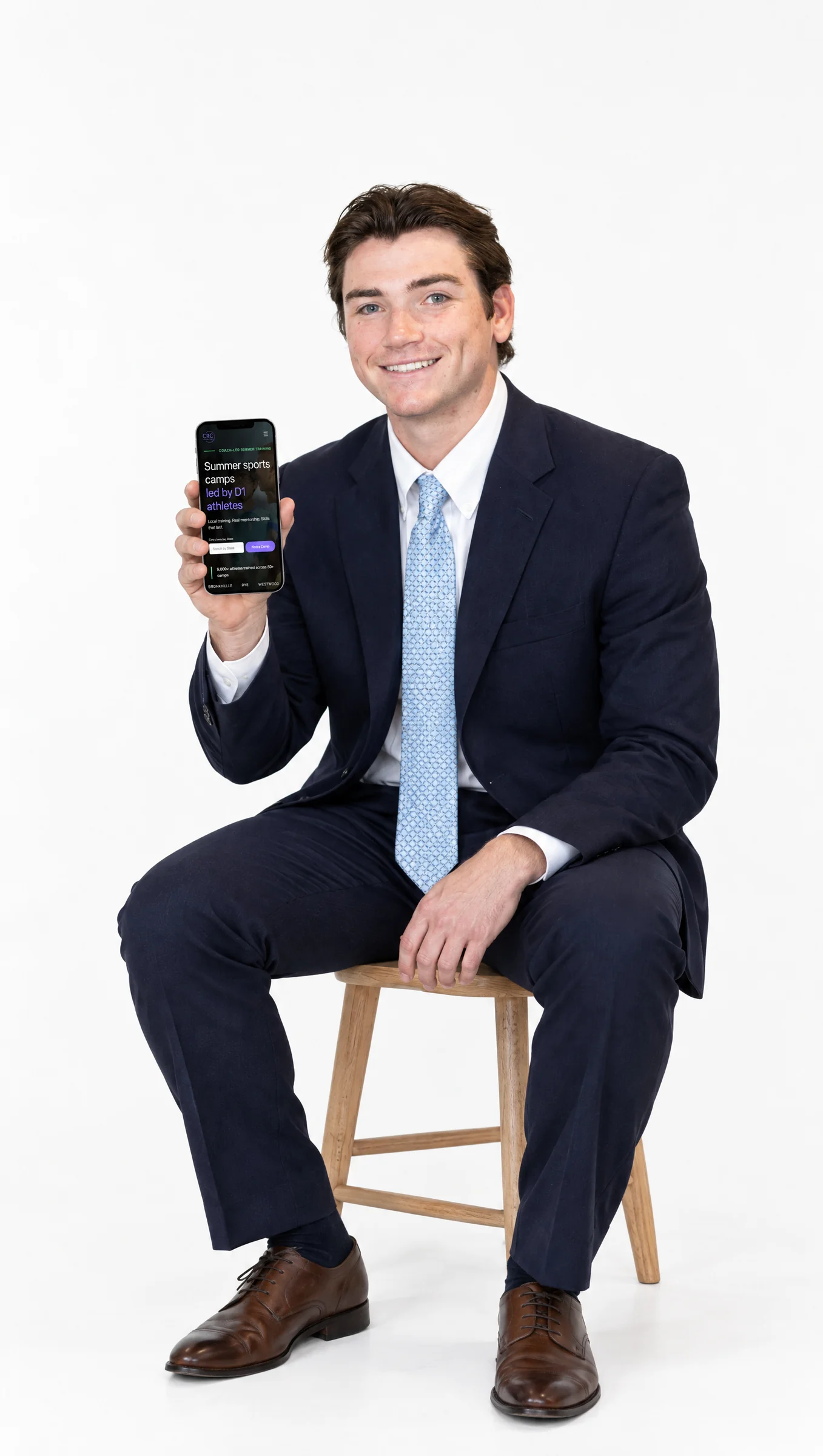 Community Run Camps founder holding the app