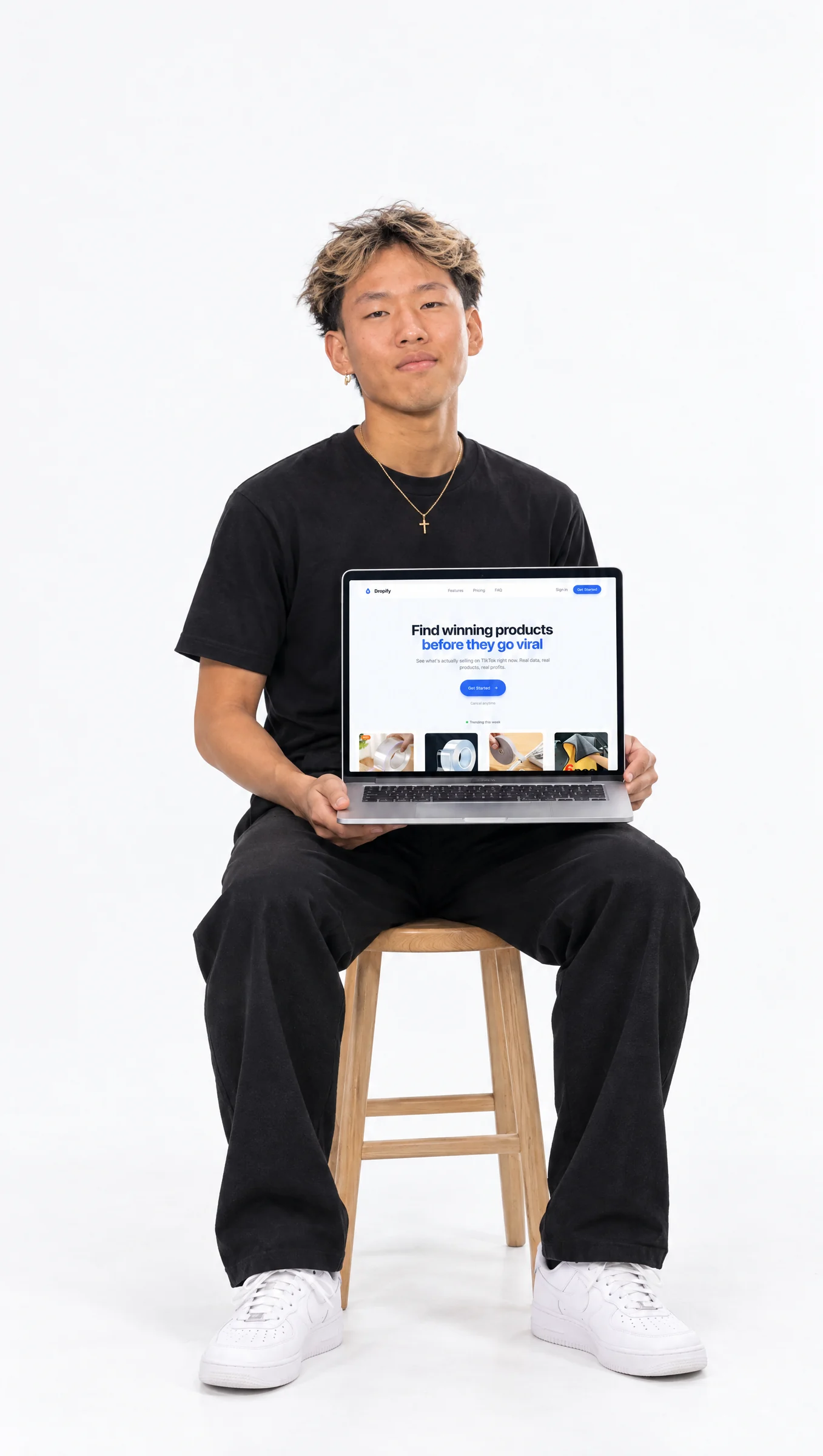 Dropify founder holding the app
